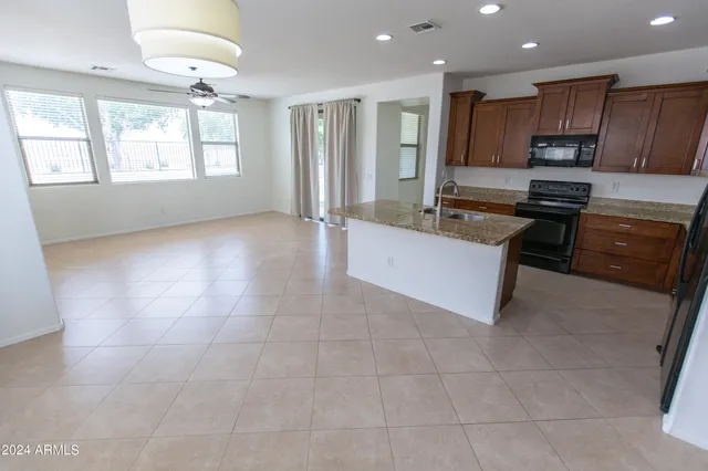 a view of a kitchen with a sink and a refrigerator