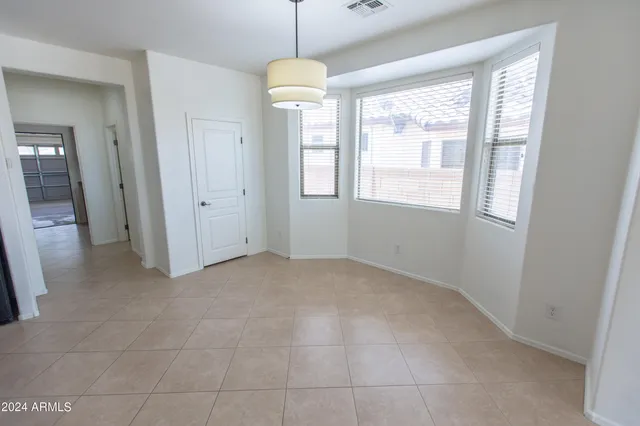 an empty room with windows and entrance