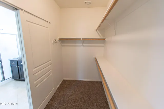 a bathroom with a granite countertop sink a mirror and a toilet