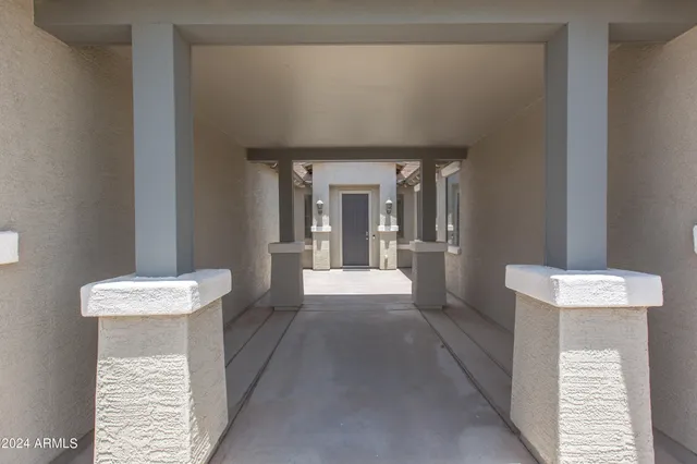 a view of an entryway door and chandelier