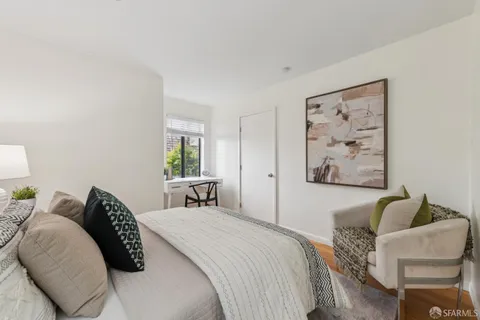 a bedroom with bed and a potted plant