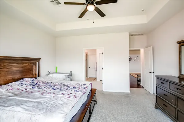 a bedroom with a bed and a dresser