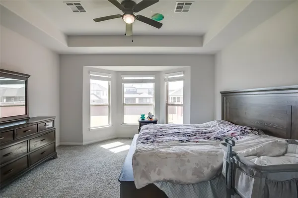 a bedroom with a bed and a chandelier