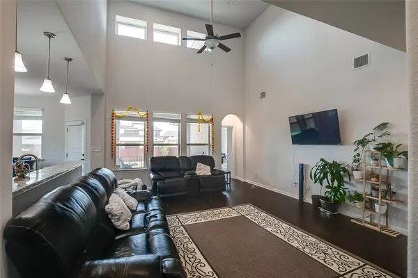 a living room with furniture and a potted plant