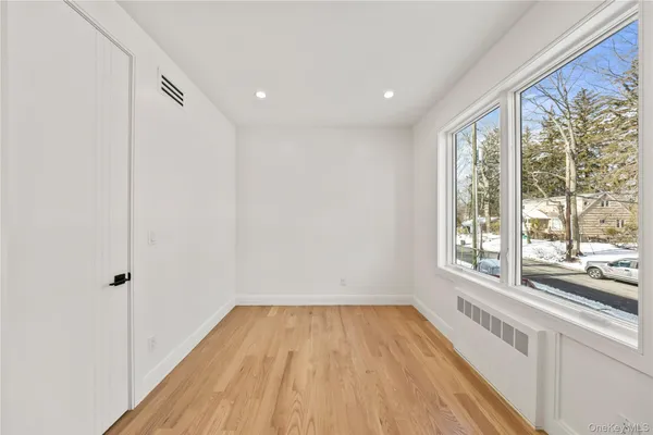 a view of a room with wooden floor and a window