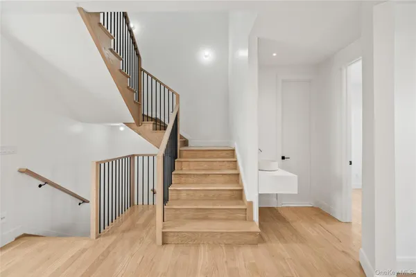 a view of entryway with wooden floor and stairs