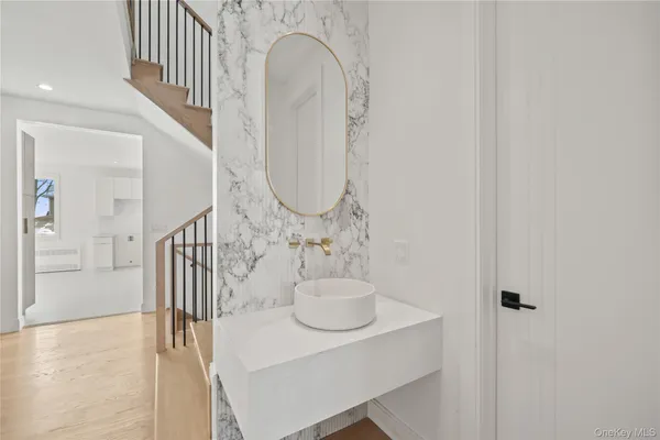 a bathroom with a sink a mirror and a toilet