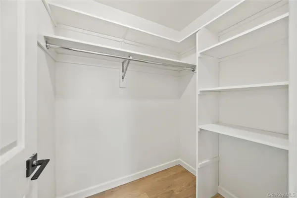 a view of walk in closet with empty racks