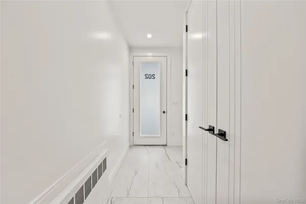 a view of a hallway with wooden floor