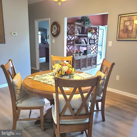 a dining room with furniture and wooden floor