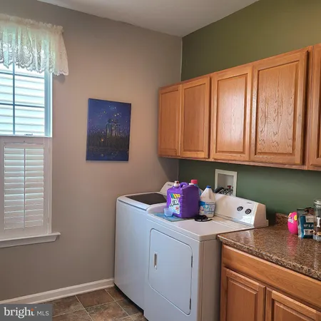 a view of a room with a window and furniture