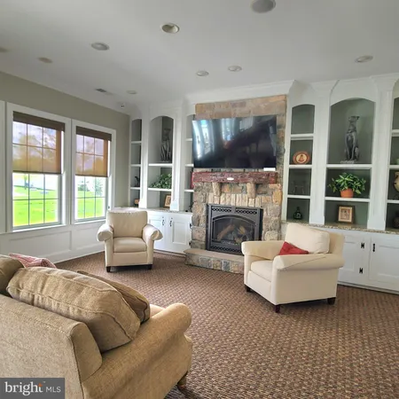 a living room with furniture a wooden floor and gym equipment