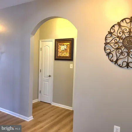 a view of a hallway with a wooden door