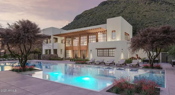 a view of a house with pool and sitting area