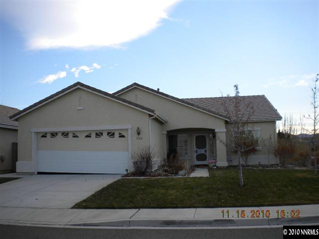 1764 Trek Trail Reno, NV 89521 - Photo 1 of 11 a front view of a house with a yard and garage