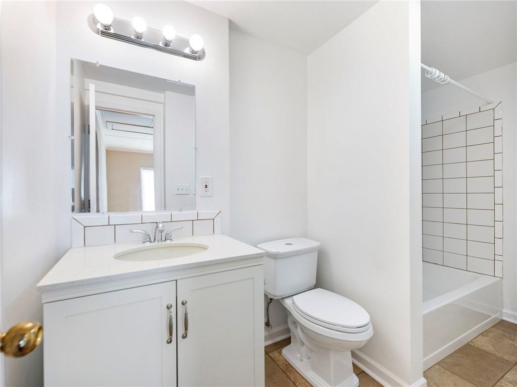 1686 Shoal Creek Road Monroe, GA 30656 - Photo 24 of 50 a bathroom with a sink a toilet and shower