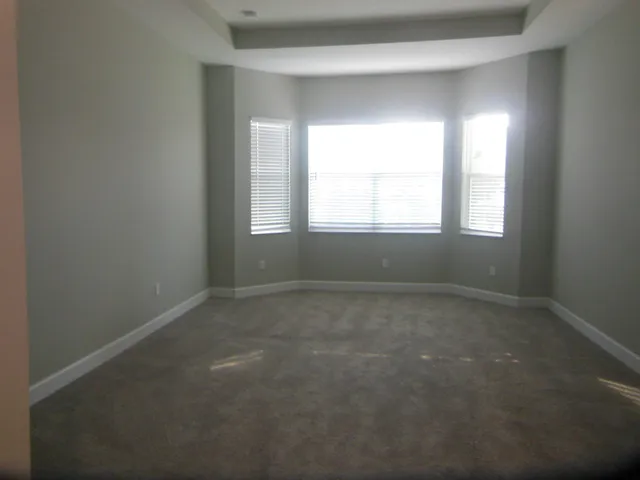 an empty room that has a window in it