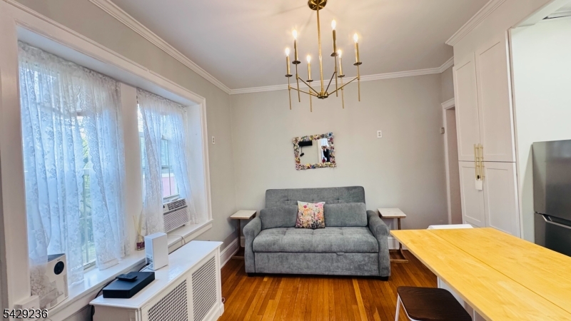 133 Summit Avenue, Unit 29 Summit, NJ 07901 - Photo 2 of 10 a bedroom with a bed and wooden floor