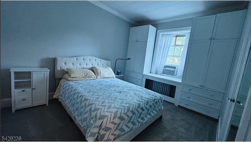 133 Summit Avenue, Unit 29 Summit, NJ 07901 - Photo 3 of 10 a bedroom with a bed and a window