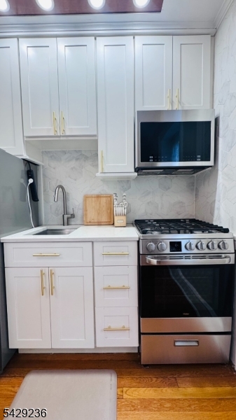 133 Summit Avenue, Unit 29 Summit, NJ 07901 - Photo 4 of 10 a kitchen with granite countertop a stove and a microwave