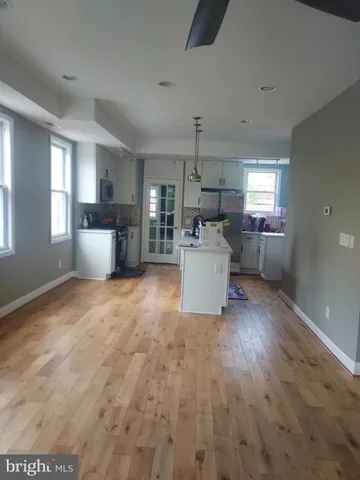 a living room with a couch and a wooden cabinets