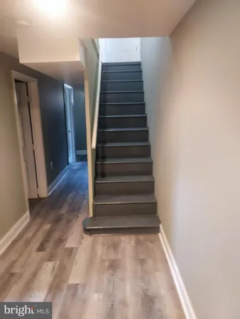 a view of hallway with wooden floor