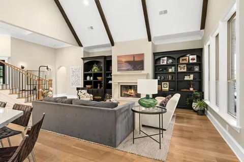 a living room with furniture wooden floor and a fireplace