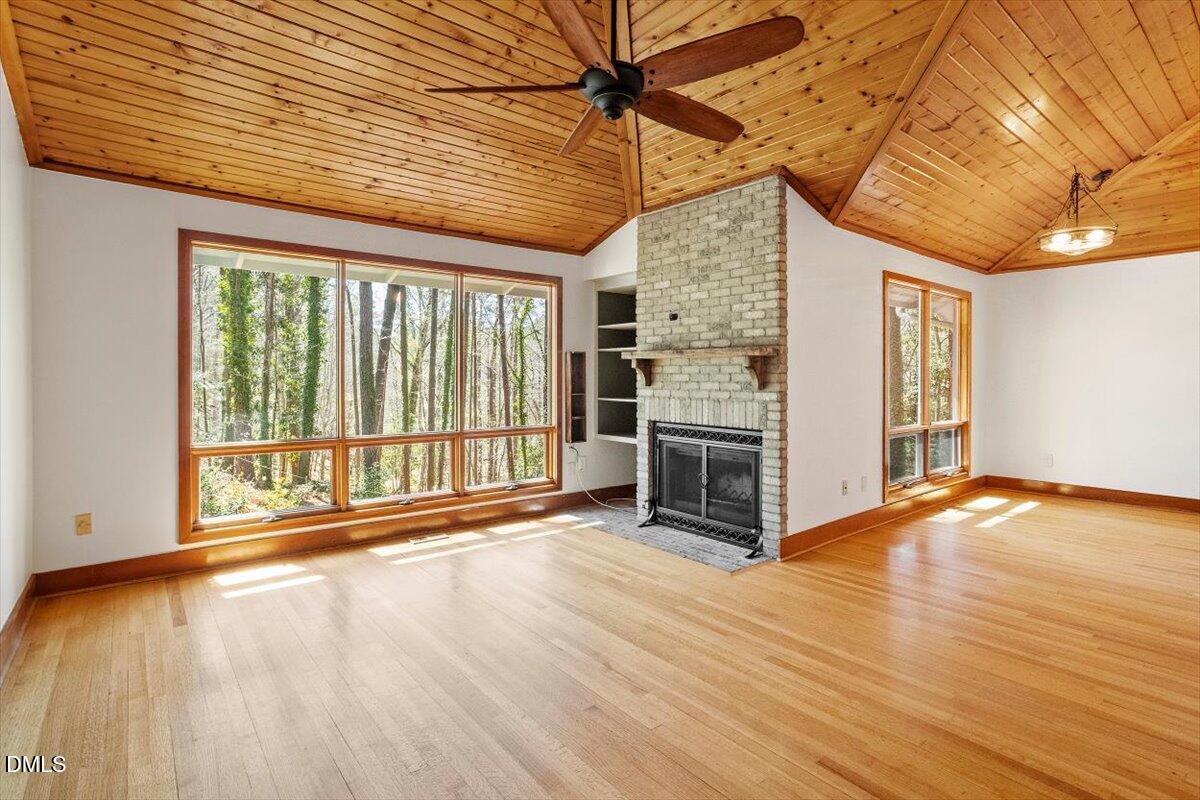 4805 Rembert Drive Raleigh, NC 27612 - Photo 14 of 45 a view of an empty room with wooden floor and a window