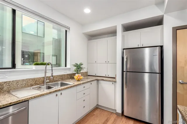 a kitchen with a refrigerator and a sink