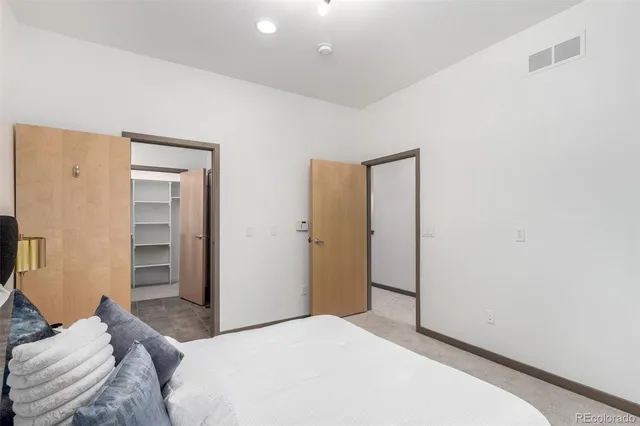 a bedroom with a bed and cabinets