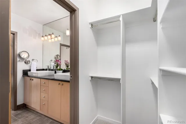 a view of a mirror and cabinets in a room