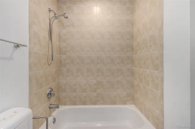 a bathroom with a bathtub and a toilet