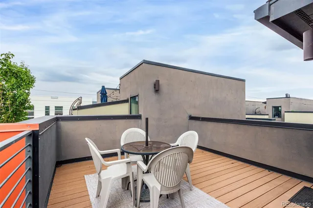 a balcony view with two chairs and a potted plant on a table