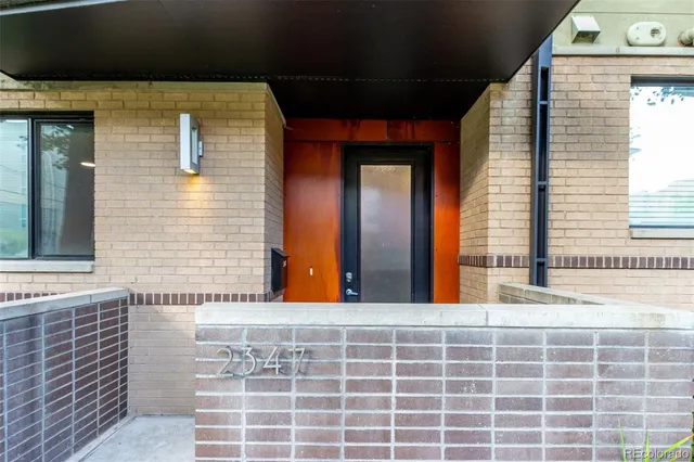a view of a brick building with many windows