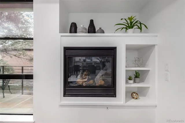a view of living room with a fireplace and a large window