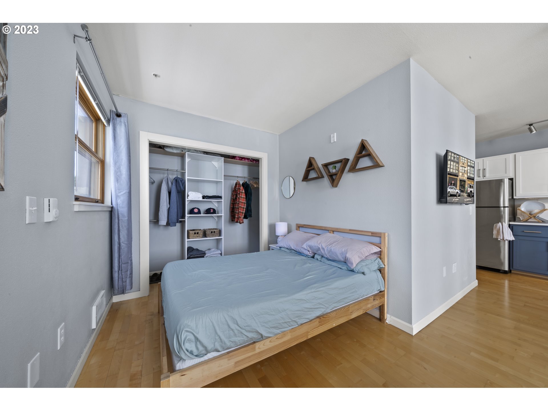 1134 Southwest Jefferson Street, Unit 405 Portland, OR 97201 - Photo 11 of 28 a bedroom with a bed and a view of kitchen