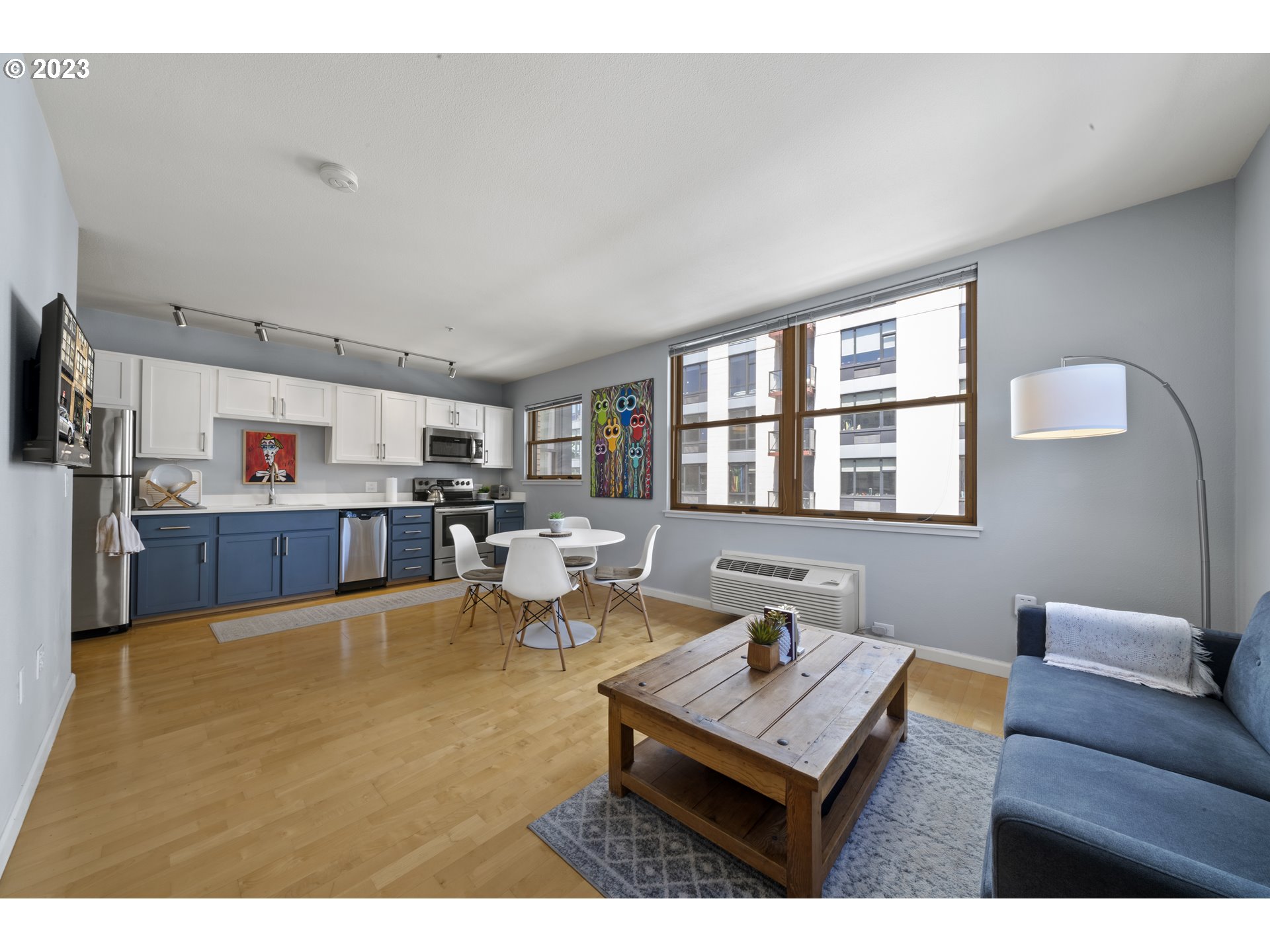 1134 Southwest Jefferson Street, Unit 405 Portland, OR 97201 - Photo 12 of 28 a living room with furniture and a book shelf