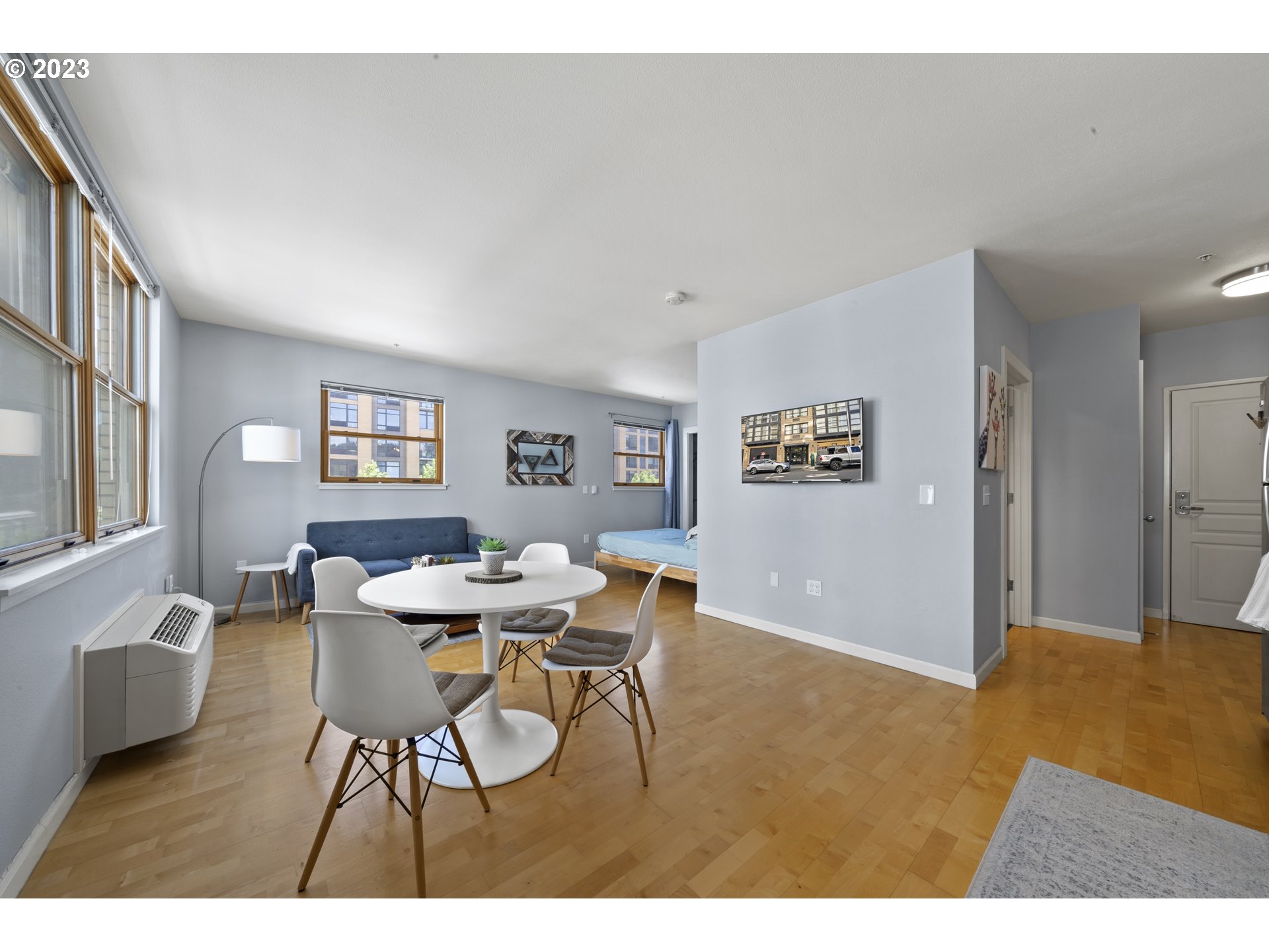 1134 Southwest Jefferson Street, Unit 405 Portland, OR 97201 - Photo 13 of 28 a view of a dining room with furniture and a potted plant