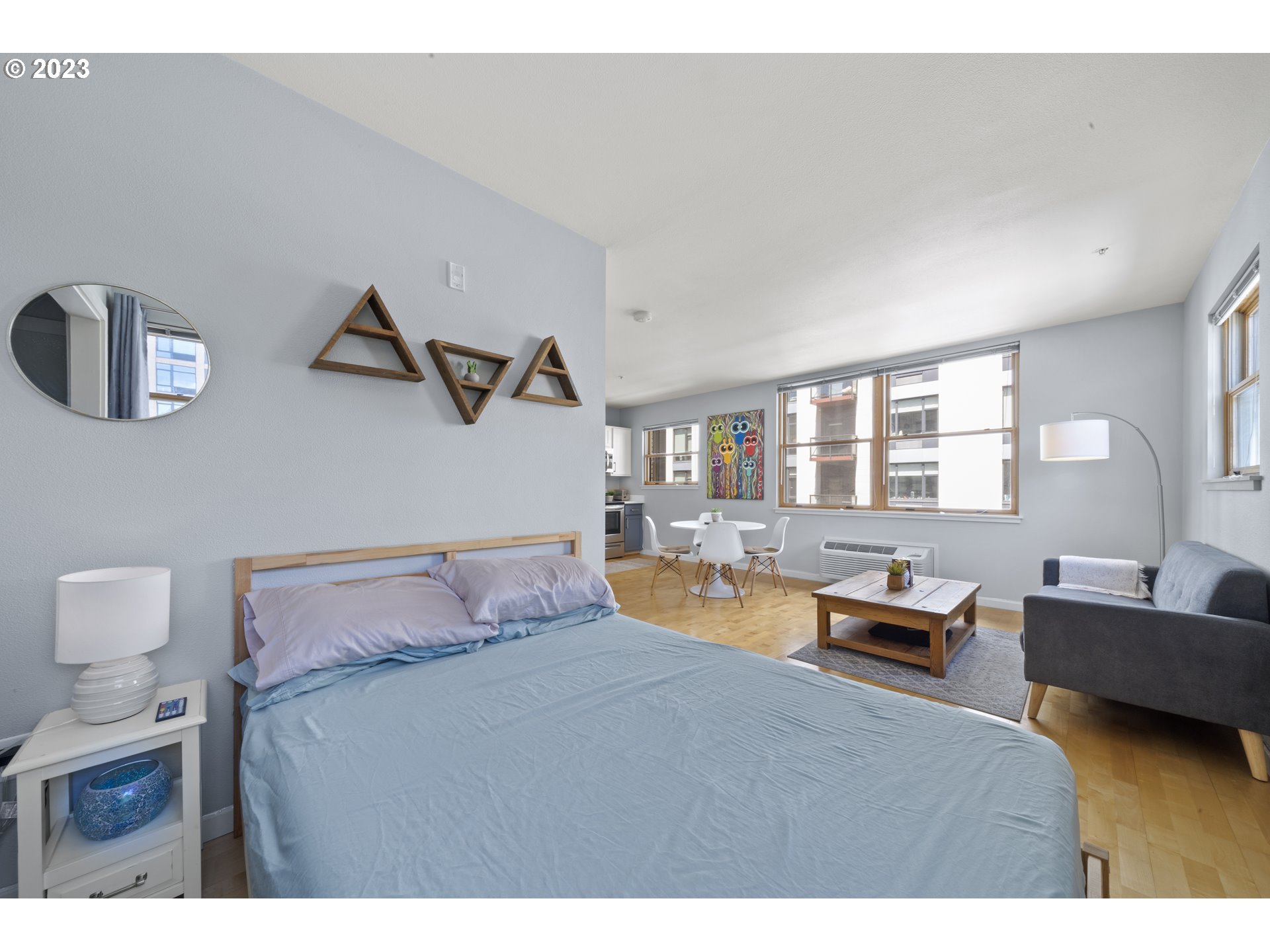 1134 Southwest Jefferson Street, Unit 405 Portland, OR 97201 - Photo 18 of 28 a bedroom with furniture and a wooden floor