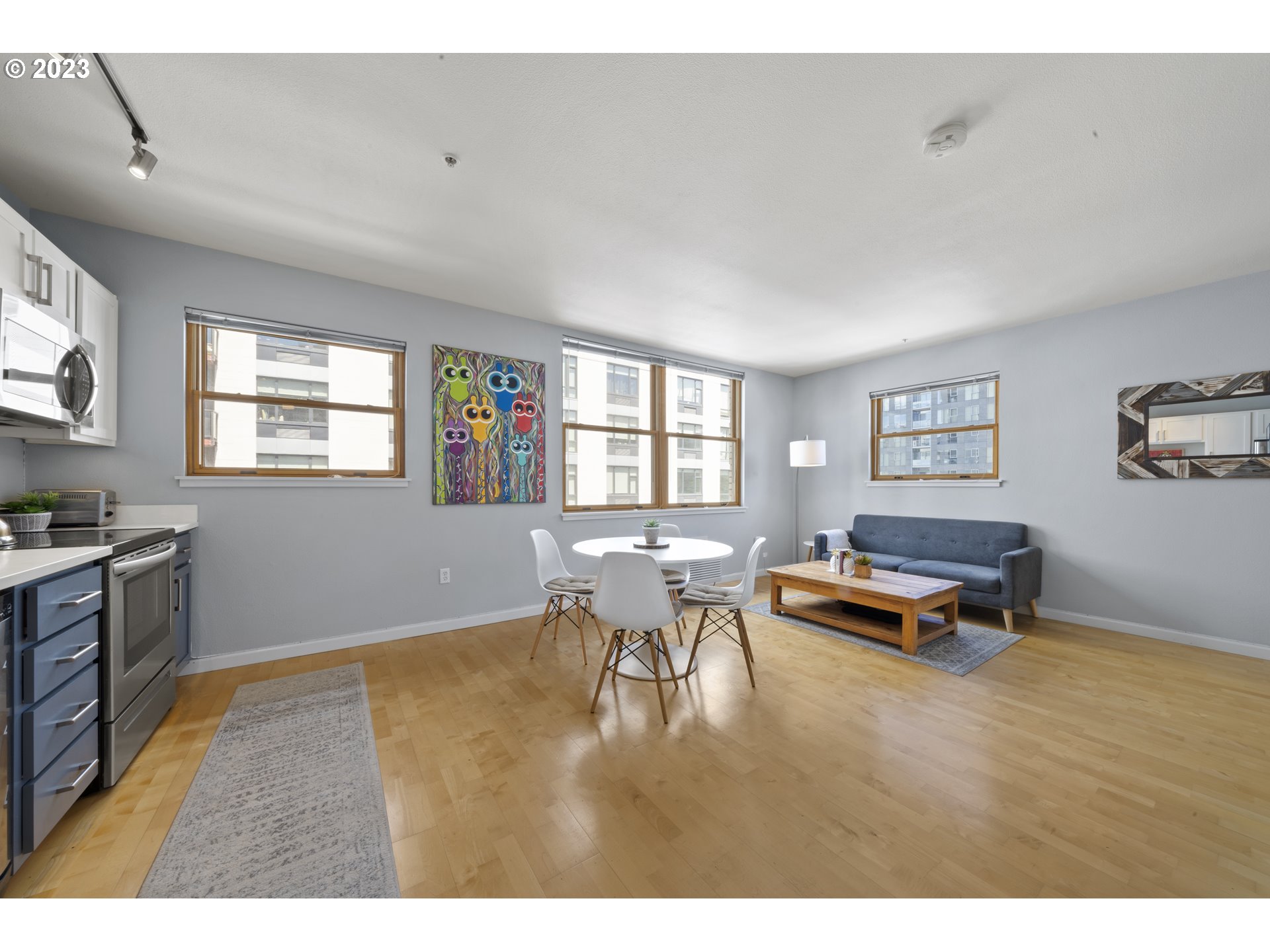 1134 Southwest Jefferson Street, Unit 405 Portland, OR 97201 - Photo 2 of 28 a living room with dining room and wooden floor