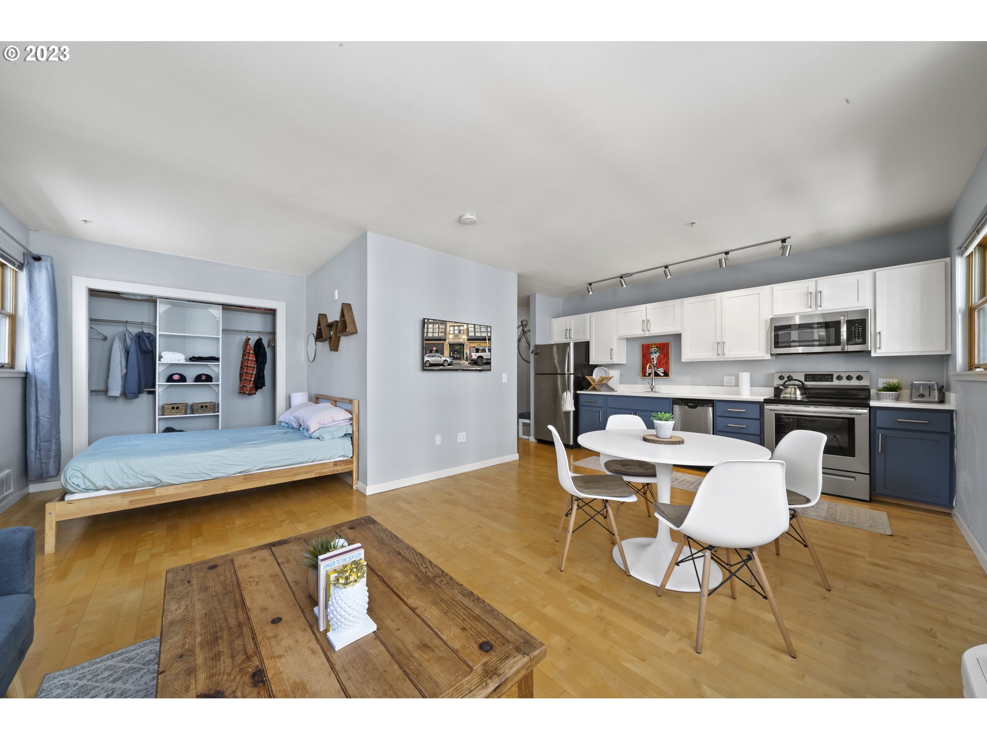1134 Southwest Jefferson Street, Unit 405 Portland, OR 97201 - Photo 3 of 28 a kitchen with stainless steel appliances kitchen island granite countertop a table and chairs