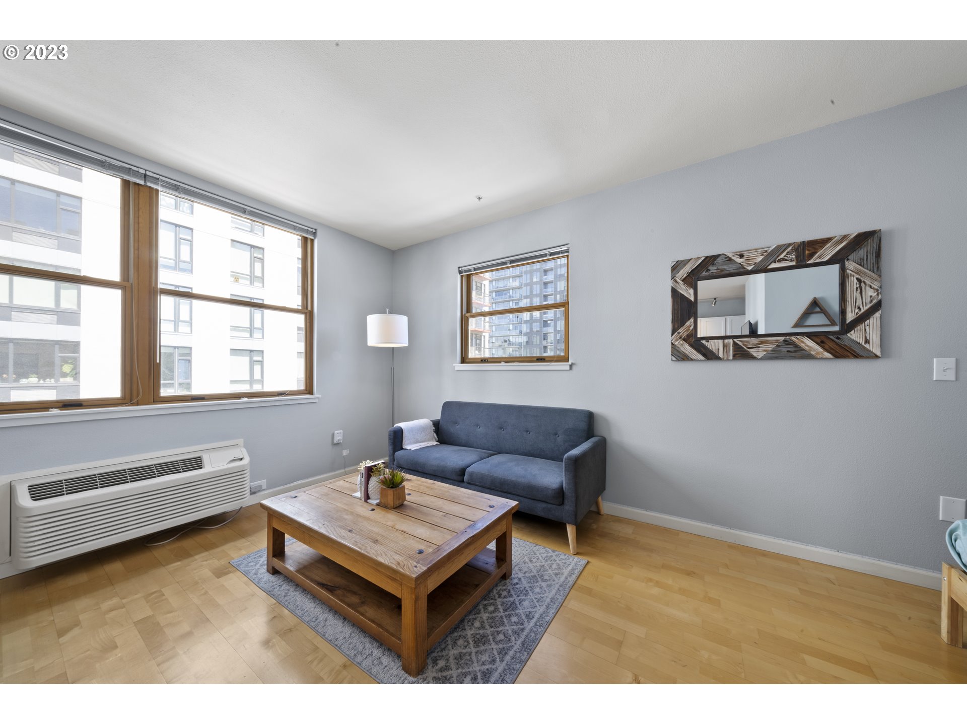 1134 Southwest Jefferson Street, Unit 405 Portland, OR 97201 - Photo 8 of 28 a living room with furniture and a window