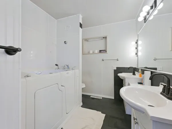 a bathroom with a sink a toilet and shower