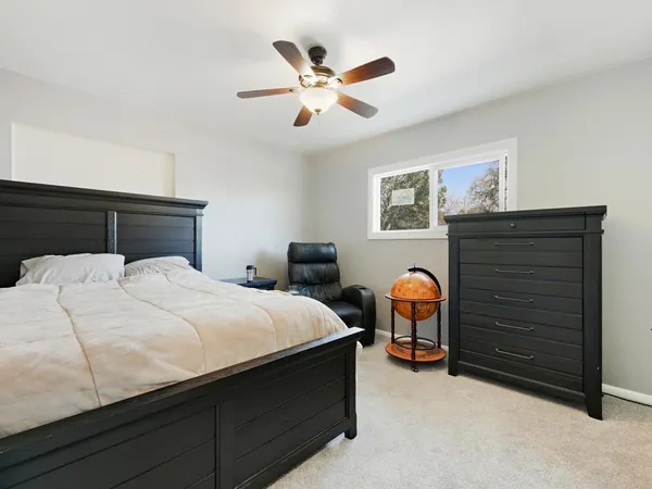 a bedroom with a bed and a chandelier