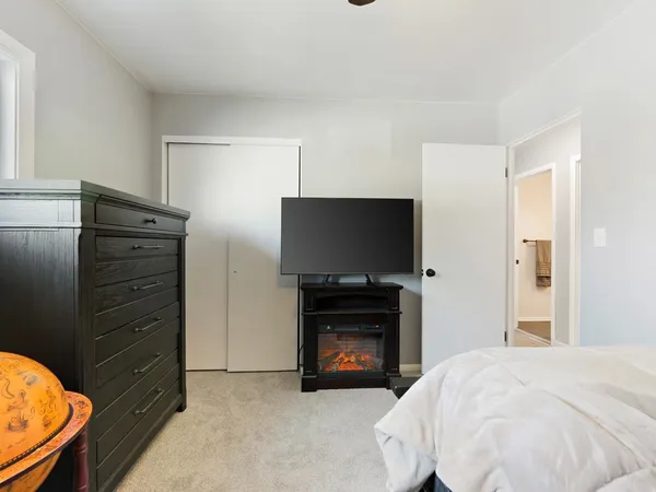 a bedroom with a bed and flat screen tv