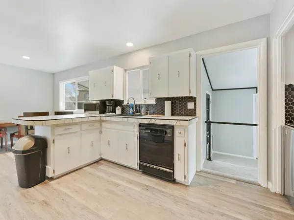 a kitchen with a sink appliances and cabinets