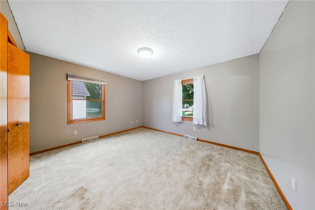 425 Overlook Drive Rittman, OH 44270 - Photo 8 of 44 Carpeted spare room with a textured ceiling and baseboards