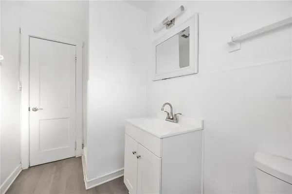 a bathroom with a sink a mirror and vanity