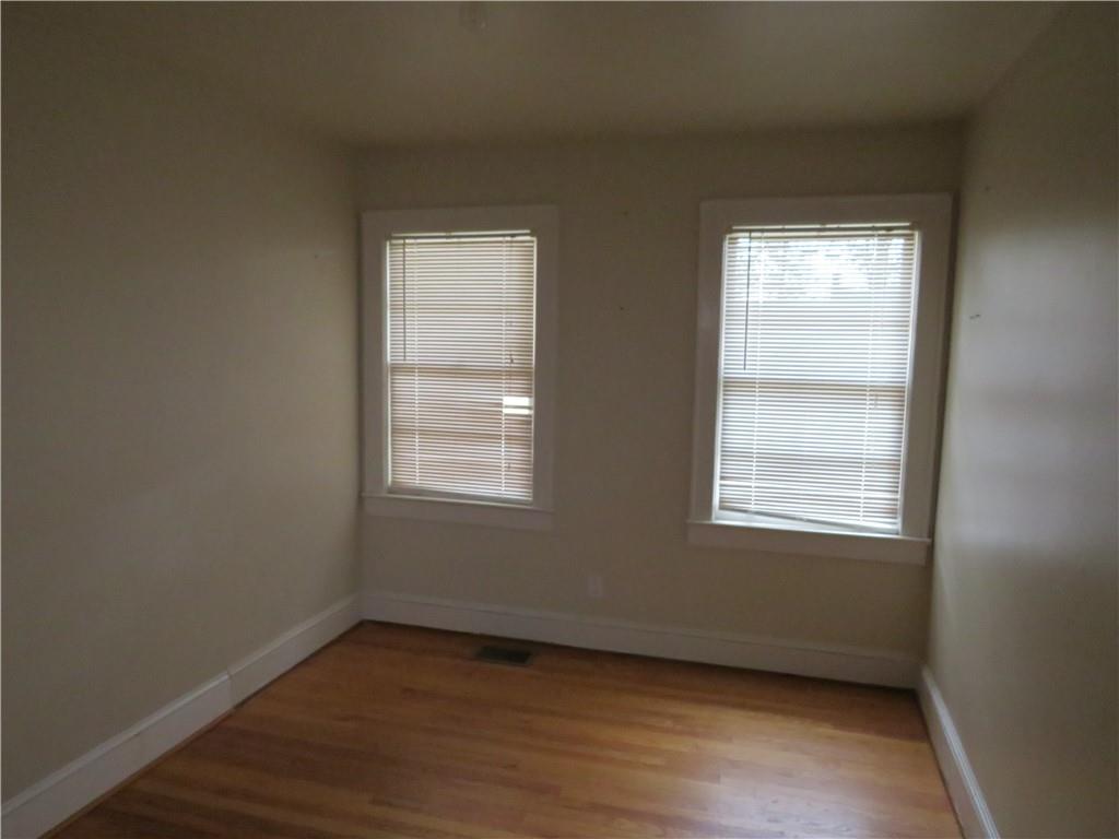 228 Marshall Street Cedartown, GA 30125 - Photo 15 of 22 an empty room with wooden floor and windows
