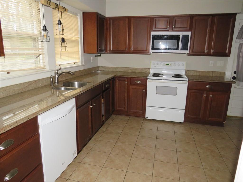 228 Marshall Street Cedartown, GA 30125 - Photo 18 of 22 a kitchen with a sink stove and microwave